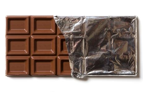 A chocolate bar with a wrapper
Description automatically generated